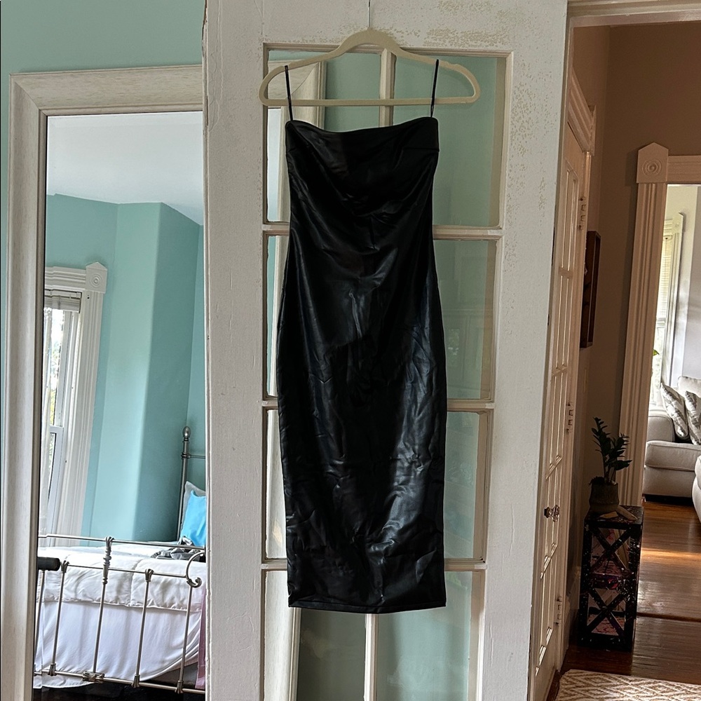 “Leather dress” fitted, sexy, knee or mid calf length black dress.